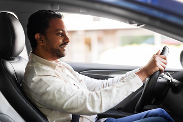 Image showing smiling indian man or driver driving car