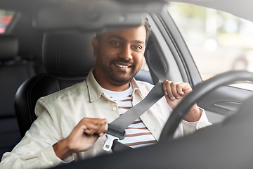 Image showing smiling indian man or driver driving car