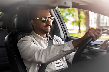 Image showing smiling indian man in sunglasses driving car