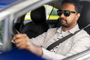 Image showing smiling indian man in sunglasses driving car