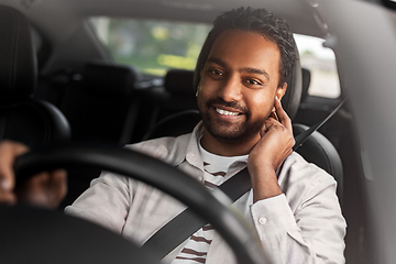 Image showing man or driver with wireless earphones driving car