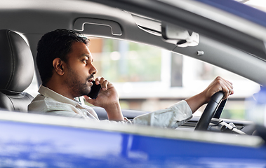 Image showing indian man driving car and calling on smartphone