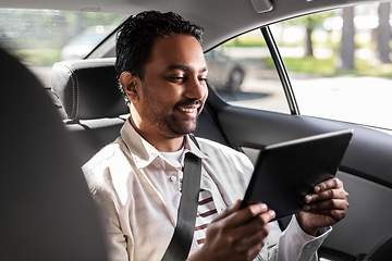 Image showing indian male passenger with tablet pc in taxi car