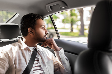 Image showing thinking indian male passenger in taxi car