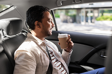 Image showing indian man with takeaway coffee on car back seat