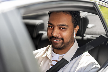 Image showing man or driver with wireless earphones driving car