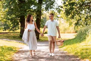 Image showing happy couple with picnic basket at summer park