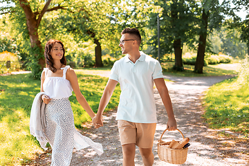 Image showing happy couple with picnic basket at summer park