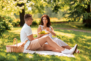 Image showing happy couple having picnic at summer park