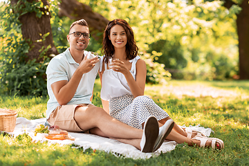 Image showing happy couple having picnic at summer park