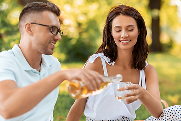 Image showing happy couple with wine having picnic at park