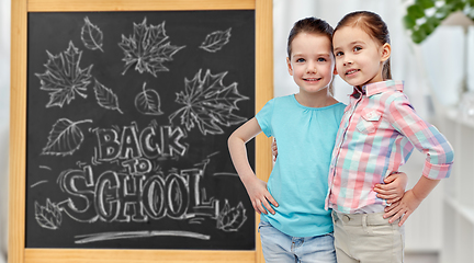 Image showing little student girls over school blackboard