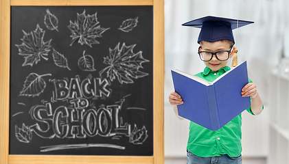 Image showing little student boy in bachelor hat and eyeglasses