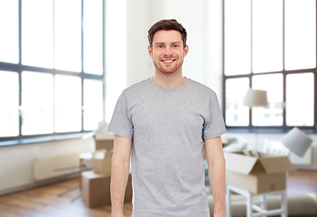 Image showing smiling young man in gray t-shirt at new home