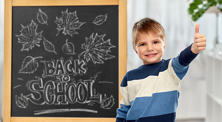 Image showing little student boy showing thumbs up