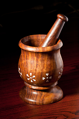 Image showing Wooden mortar and pestle on dark