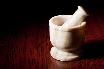 Image showing Marble mortar and pestle on dark