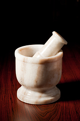 Image showing Marble mortar and pestle on dark