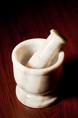 Image showing Marble mortar and pestle on dark