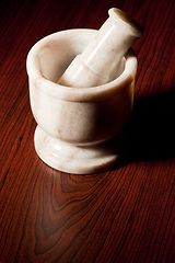 Image showing Marble mortar and pestle on dark