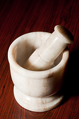 Image showing Marble mortar and pestle on dark