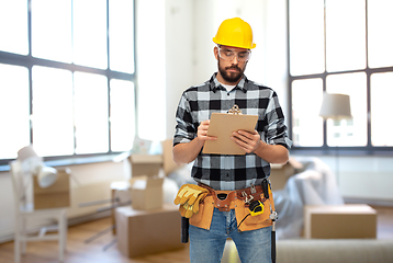 Image showing male builder in helmet with clipboard at home