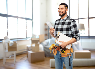 Image showing male builder with clipboard and blueprint at home