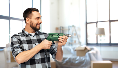 Image showing happy man, worker or builder with drill at home