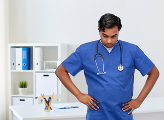 Image showing stressed doctor or male nurse in blue uniform