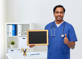 Image showing happy indian male doctor or nurse with chalkboard