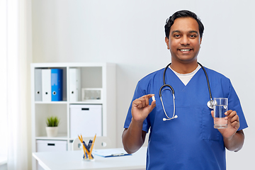 Image showing indian doctor with medicine and glass of water