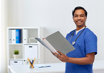 Image showing happy indian doctor with medical report in folder