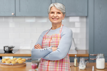 Image showing portrait of smiling senior woman at kitchen