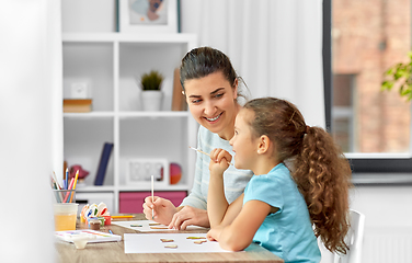 Image showing happy mother with little daughter drawing at home