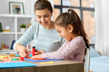 Image showing daughter with mother making applique at home