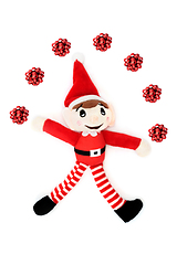 Image showing Christmas Elf Juggling Red Bow Decorations