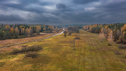 Image showing Partly abandoned meadows under cloudy sky