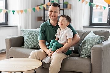 Image showing happy father and little son at home birthday party