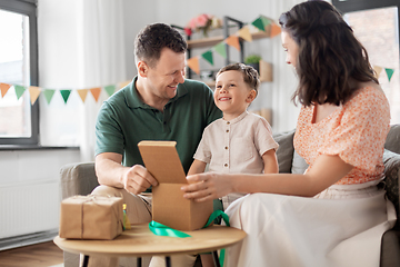 Image showing happy family opening birthday presents at home