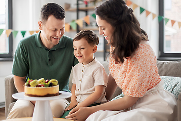 Image showing happy family with birthday cake at home