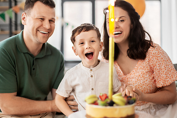 Image showing happy family with birthday cake at home