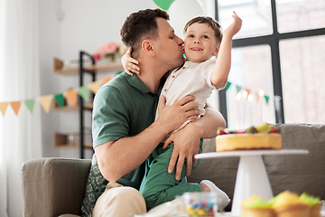 Image showing father kissing little son at home birthday party