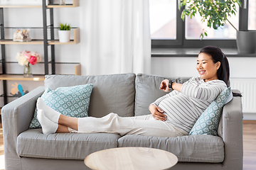 Image showing happy pregnant woman with smart watch at home