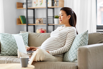 Image showing pregnant asian woman with laptop at home