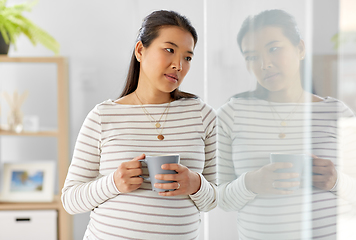 Image showing sad pregnant woman drinking tea at home