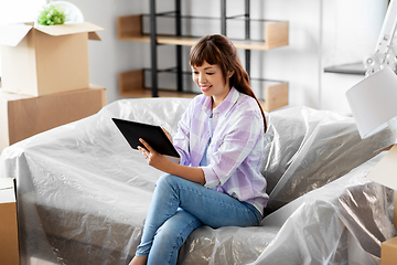 Image showing asian woman with tablet pc moving into new home