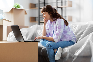 Image showing woman with laptop moving into new home