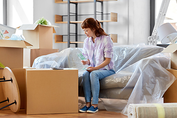 Image showing asian woman moving to new home and counting money