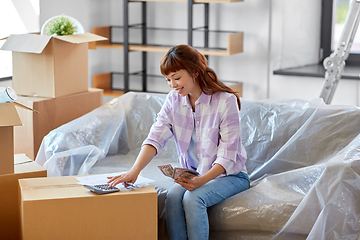 Image showing asian woman moving to new home and counting money