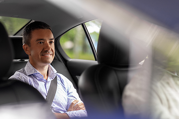 Image showing smiling middle aged male passenger in taxi car